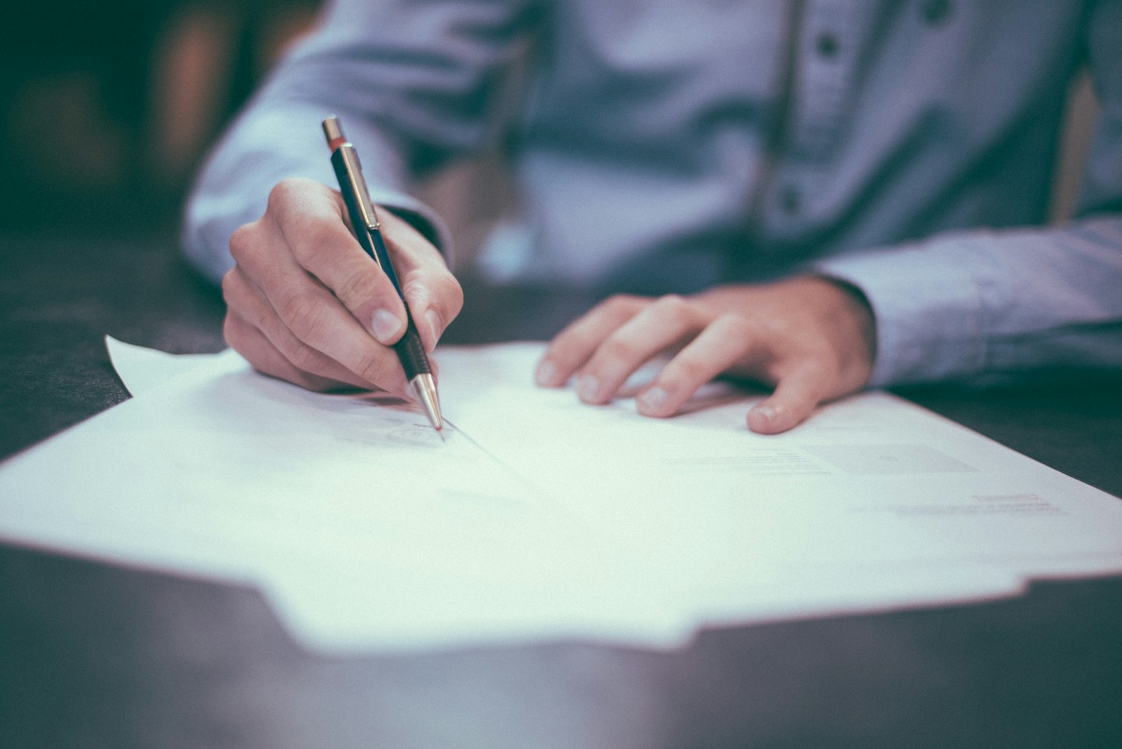 Property sourcer reviewing documents and analysing a potential investment deal